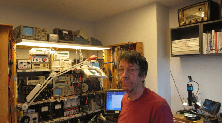 Christian Fromentin in his electronics workspace with test equipment