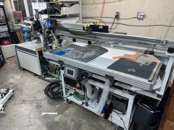 Workspace with a laser cutter built around a Coherent 150W CO2 laser that can cut thin steel and stainless.