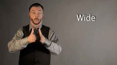 Man illustrating the word "wide" with his hands