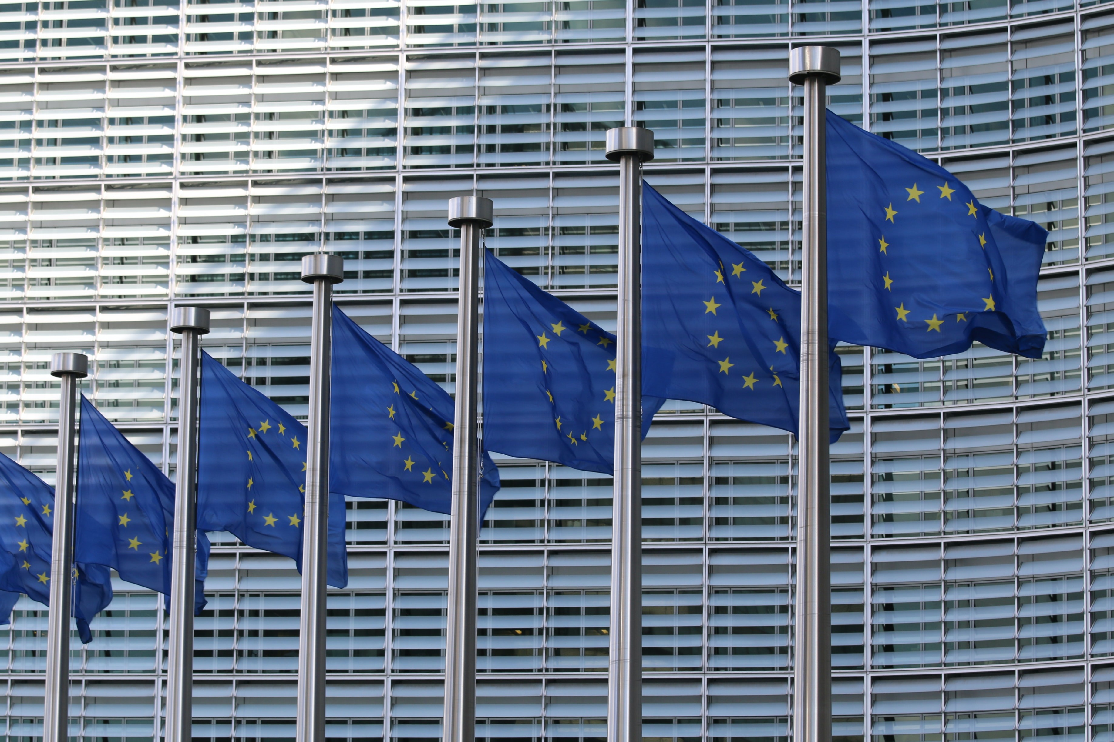 EU flags at the European Commission Berlaymont building. (Photo by Guillaume Périgois via Unsplash)